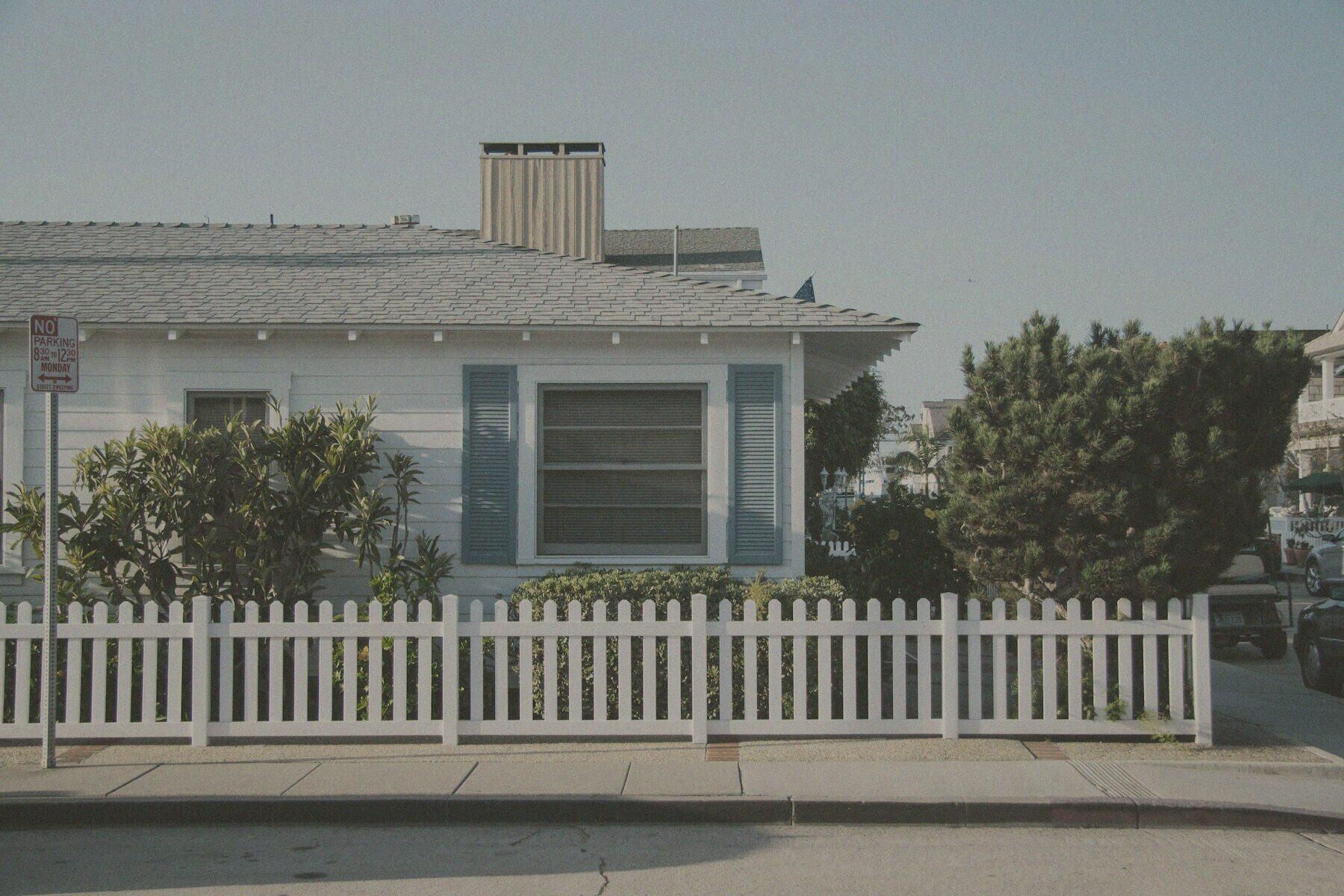 Simulated before view: the same home shown faded and weathered.
